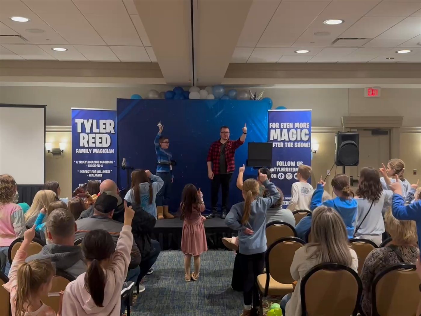 Every hand in the room shoots up as Tyler takes the stage with a young volunteer