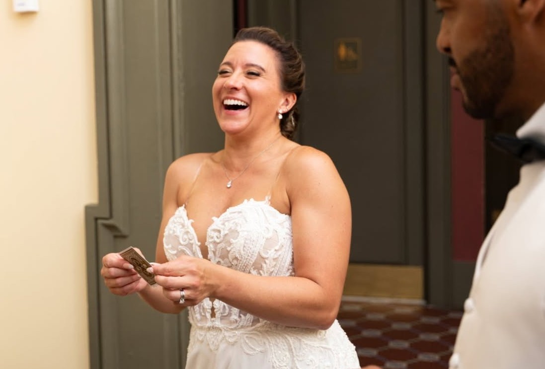 A bride laughs with delight during a close-up magic moment