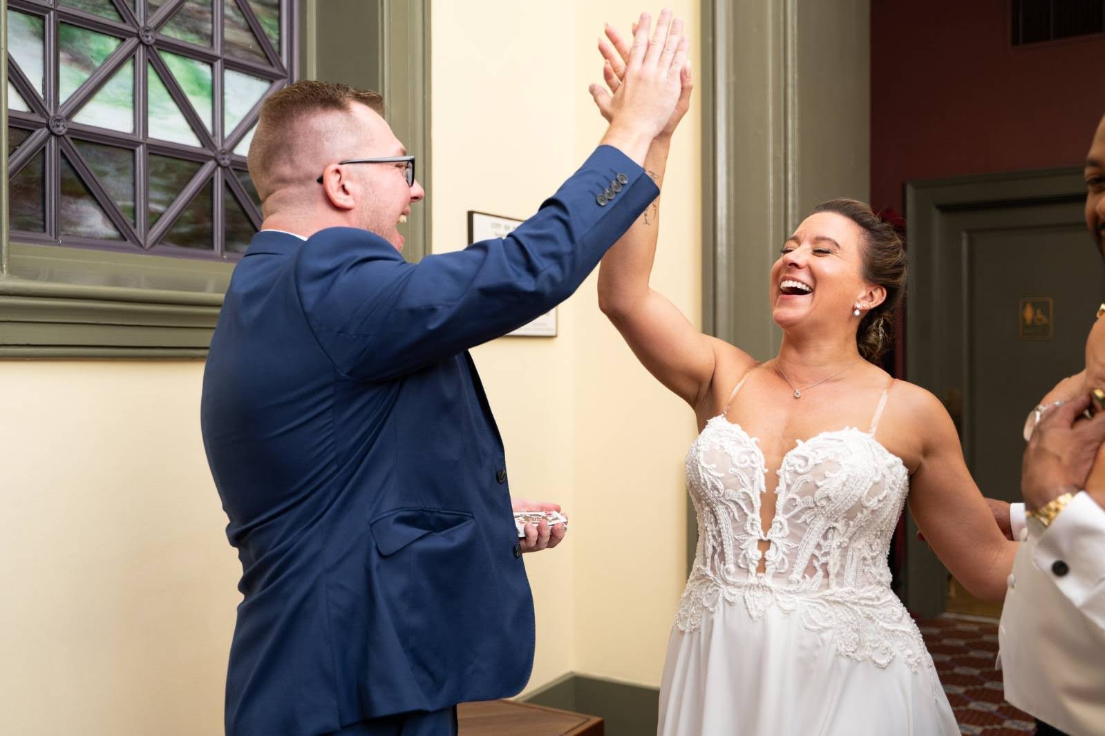 Tyler and a laughing bride share a high five after a card trick lands